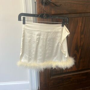 white mini satin skirt feather trim